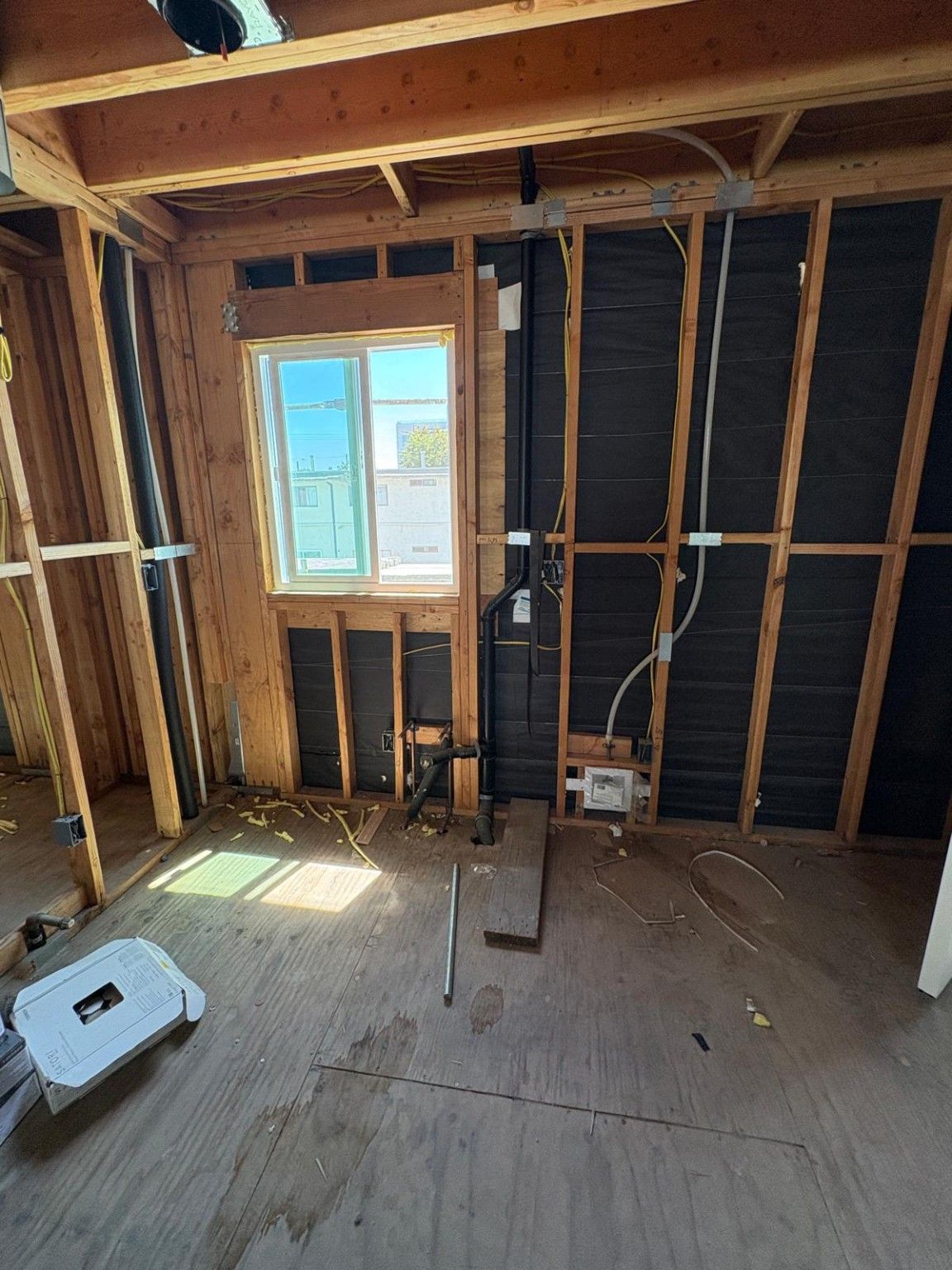 Interior wall framing with a window and plumbing rough-in