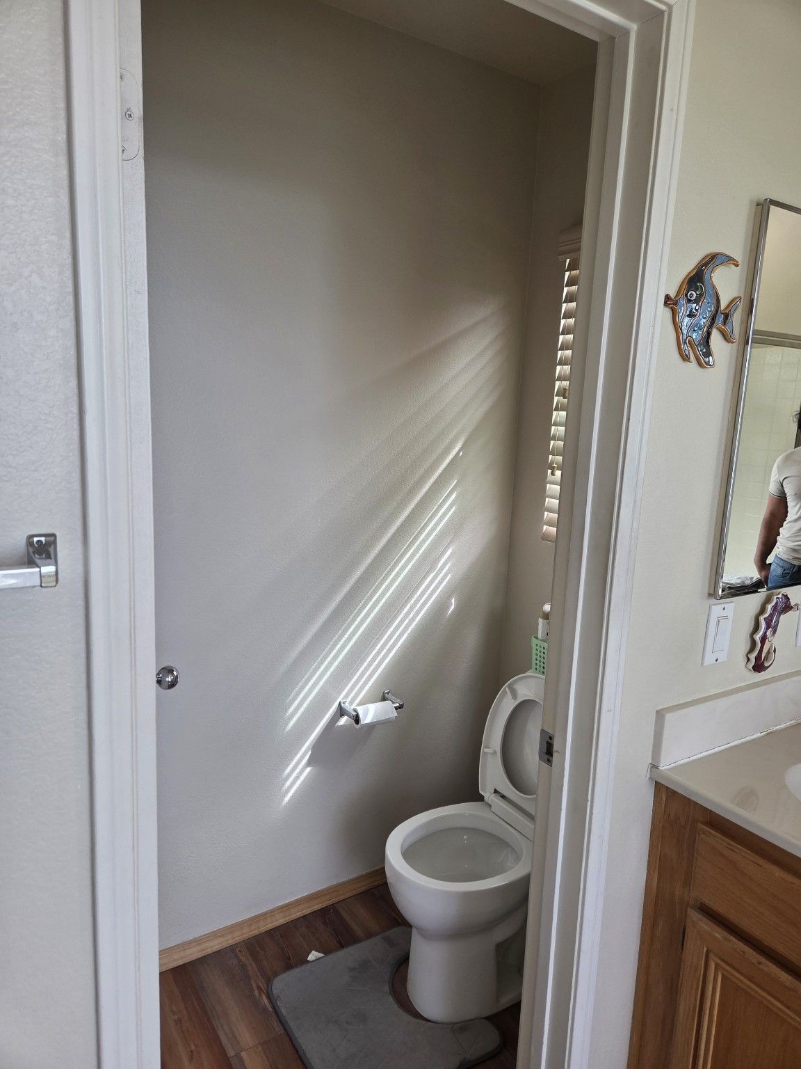 Original toilet room and the adjoining wood vanity.