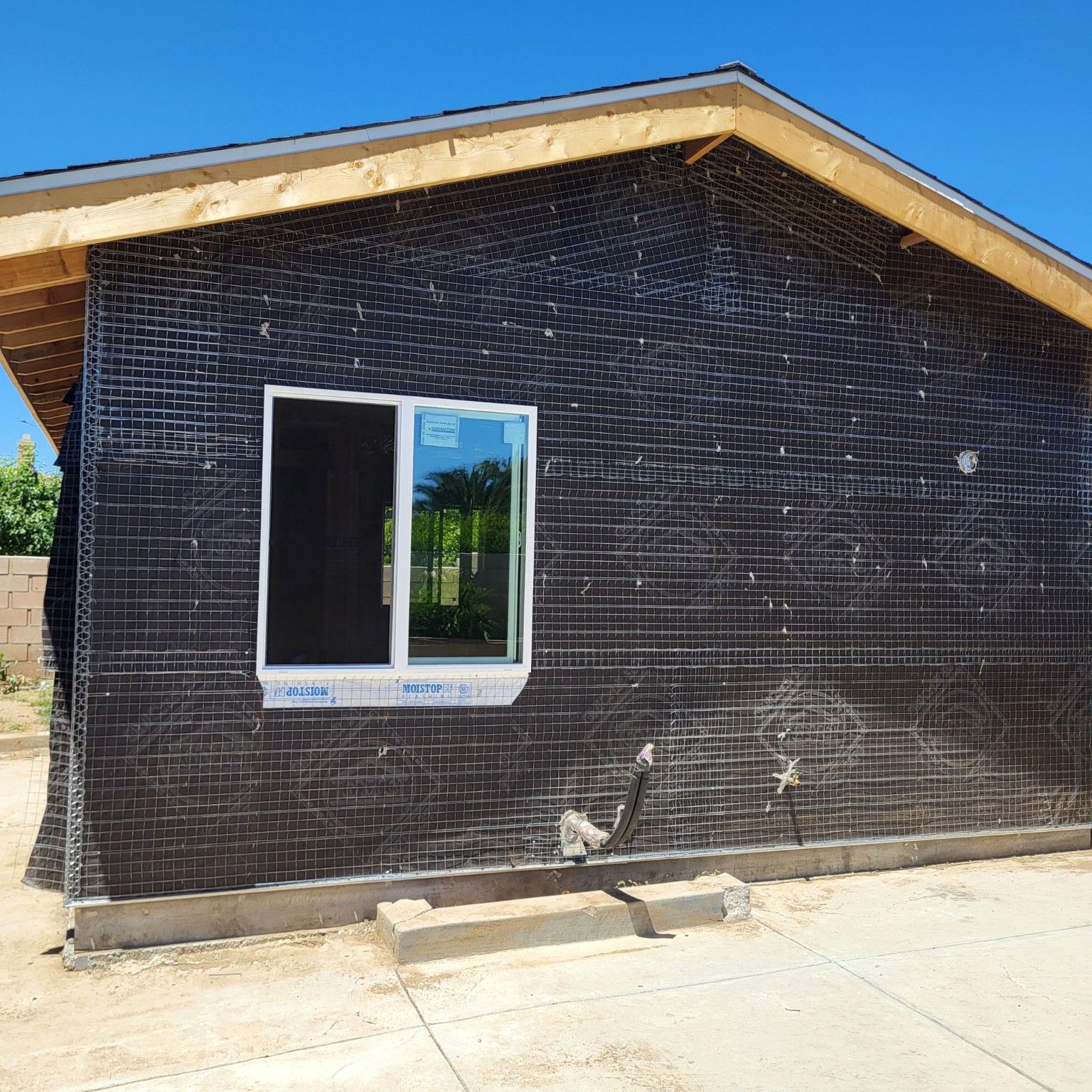 Exterior wall preparation around a window before the finish coat