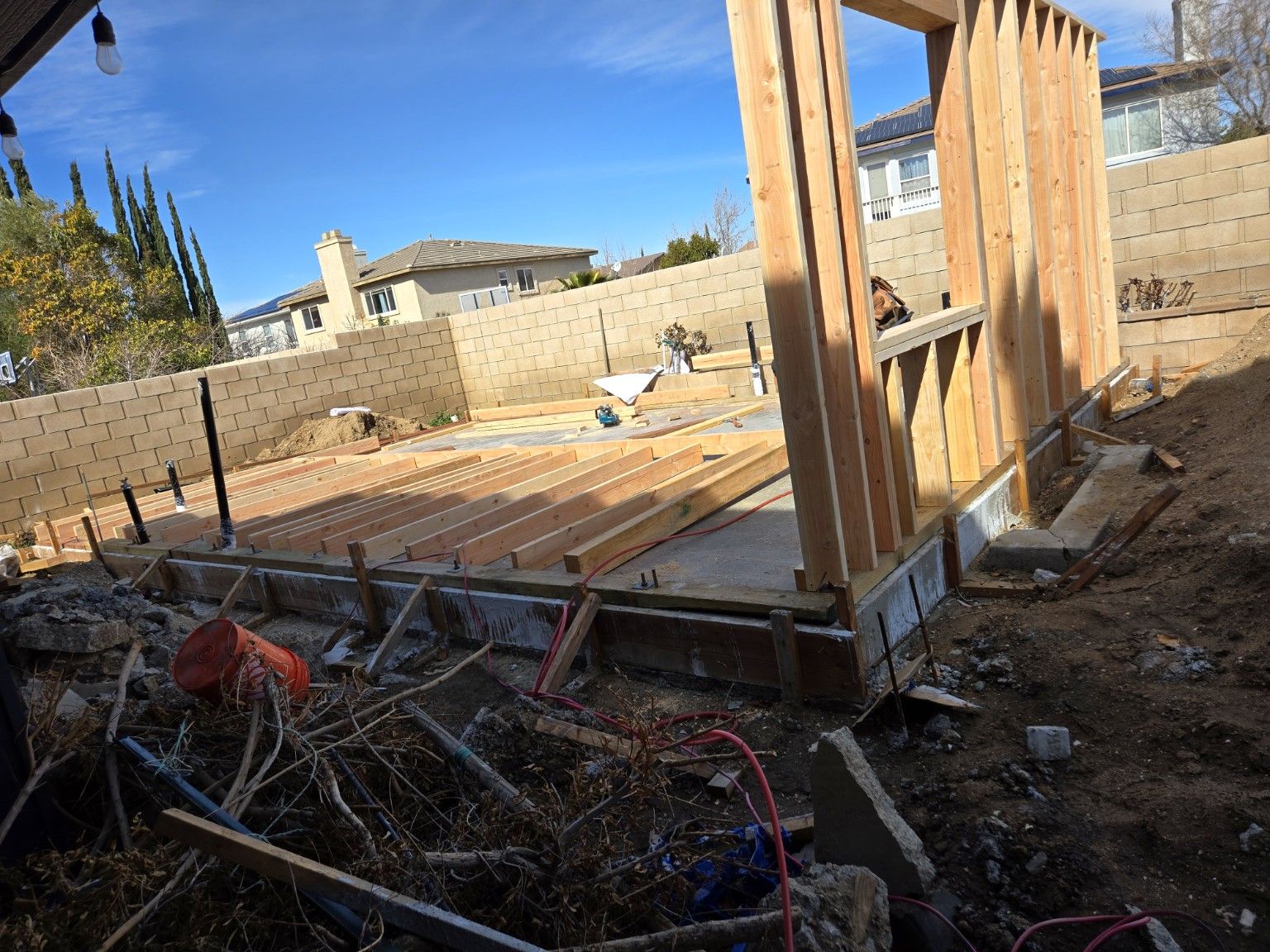 Wood floor and wall framing with construction materials around the site
