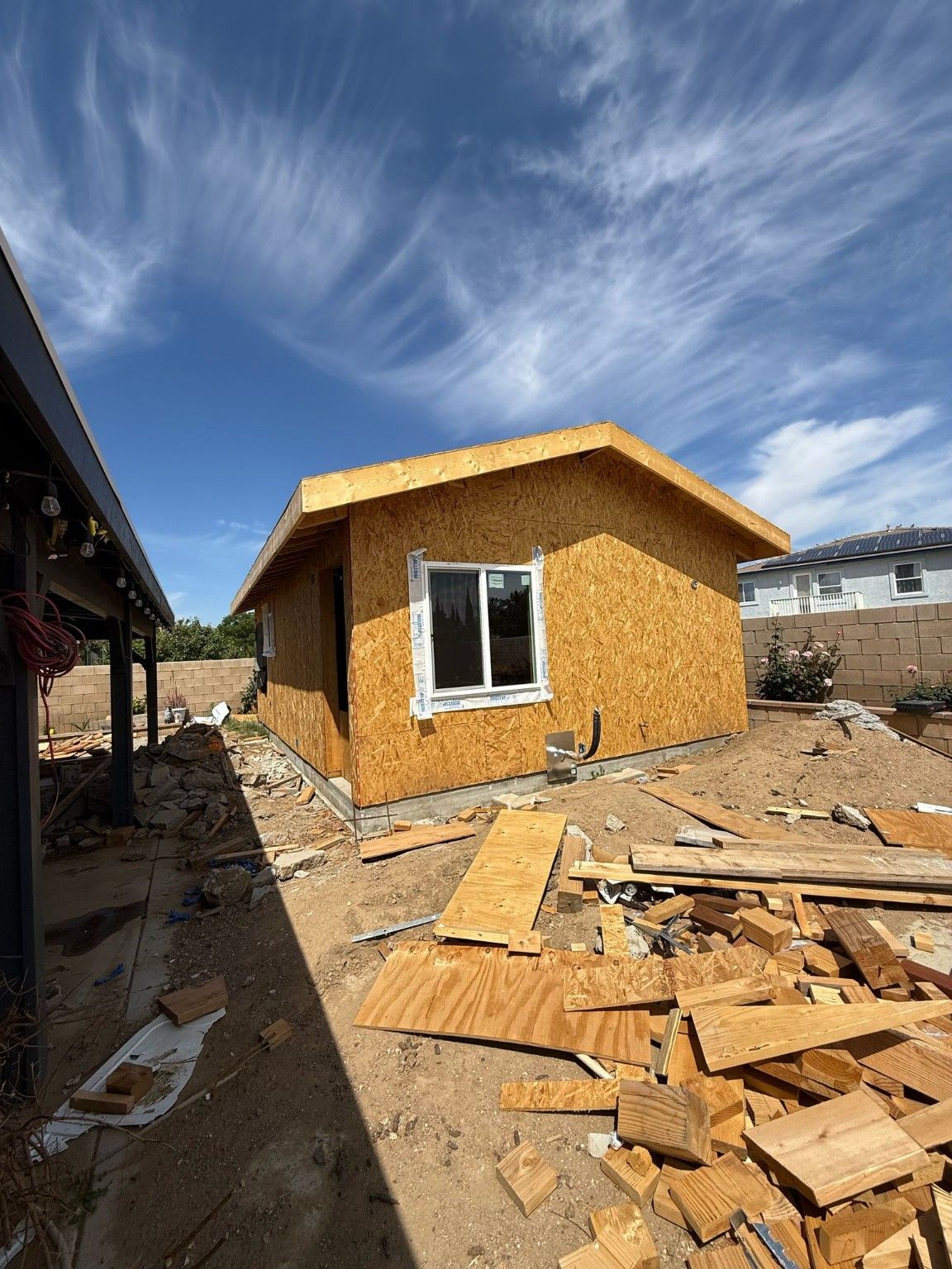 Gable-end view of a small building with exposed sheathing