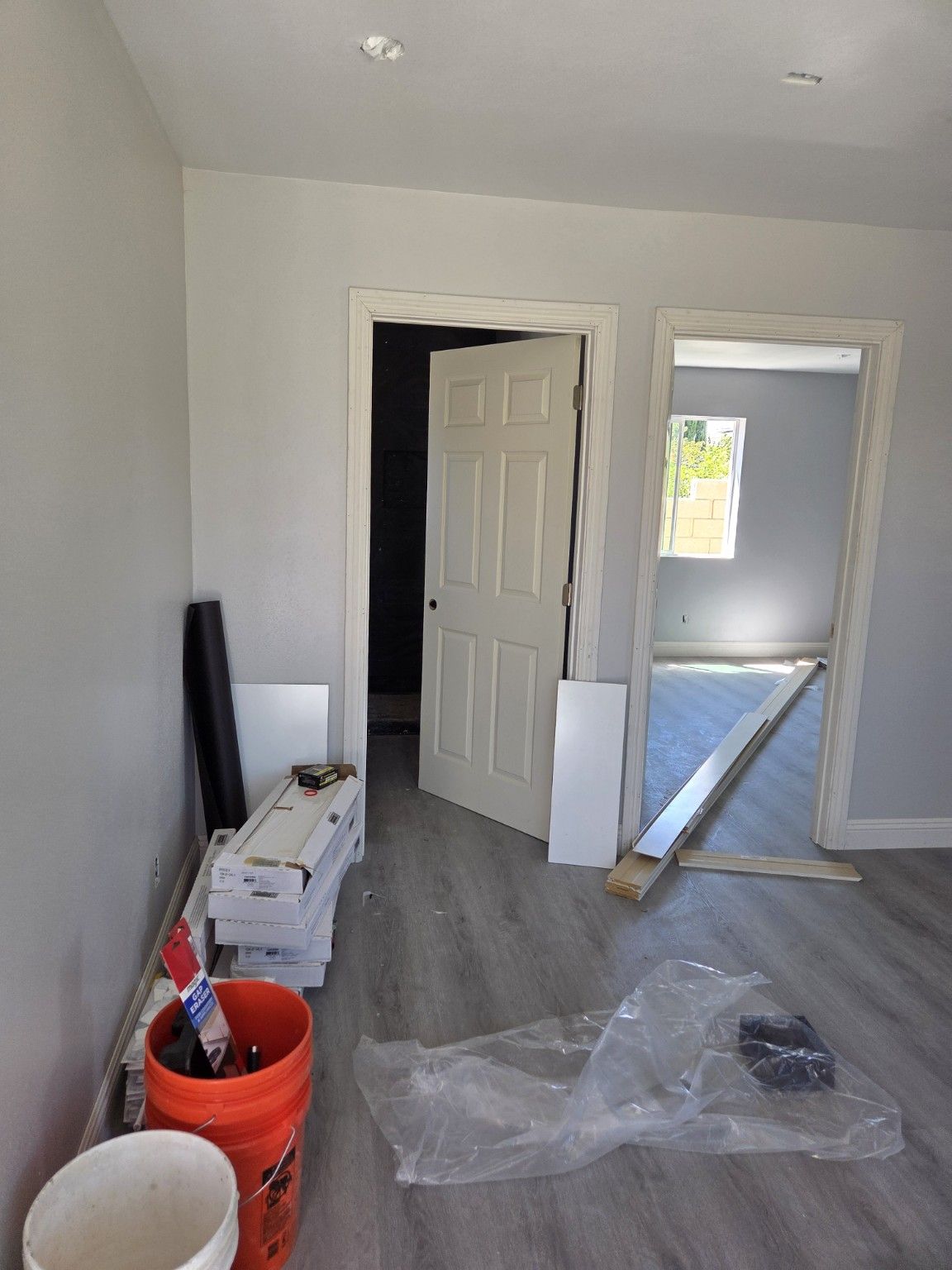 Interior room with doorways, flooring and construction materials