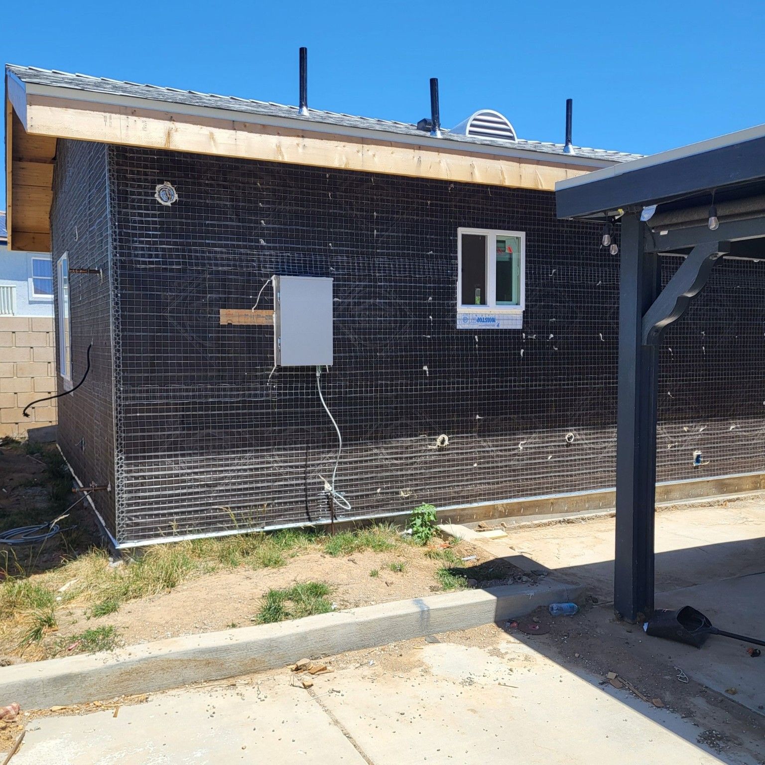 Exterior wall preparation with utility connections and a window