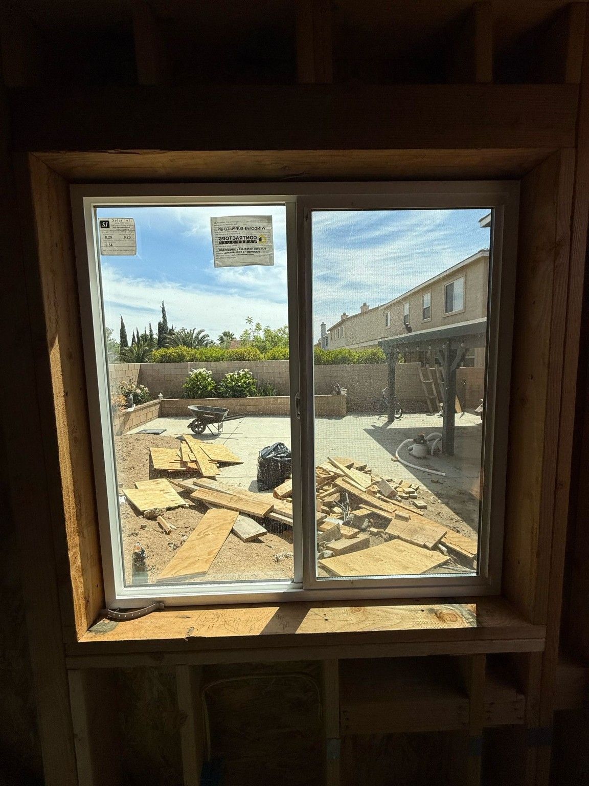 Interior view through a window surrounded by exposed wood framing