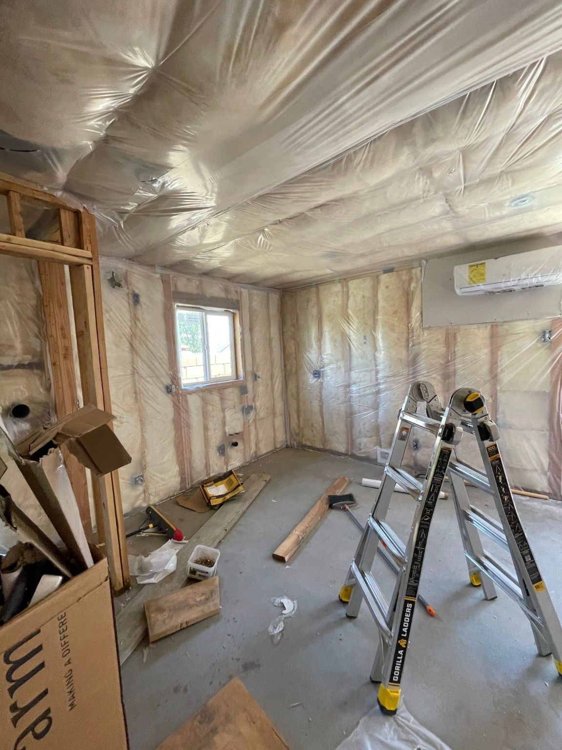 Interior framing and insulation with ladders and work materials