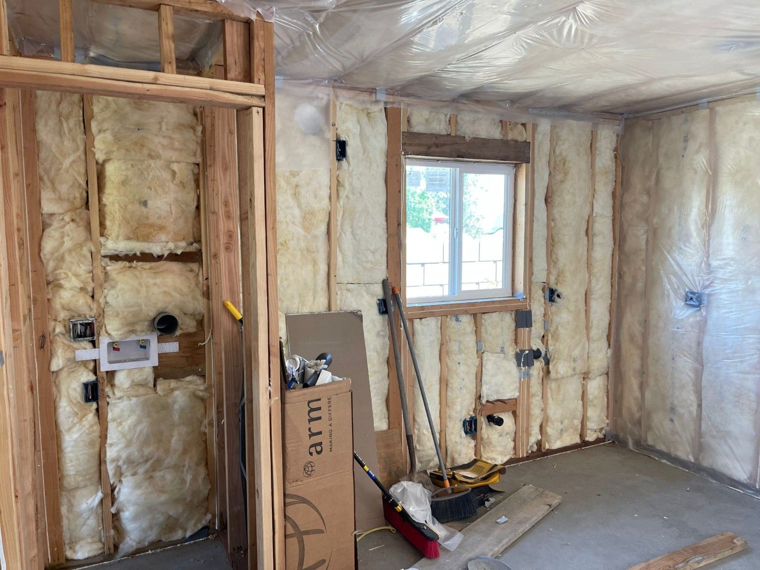 Insulated wall framing around plumbing and utility connections