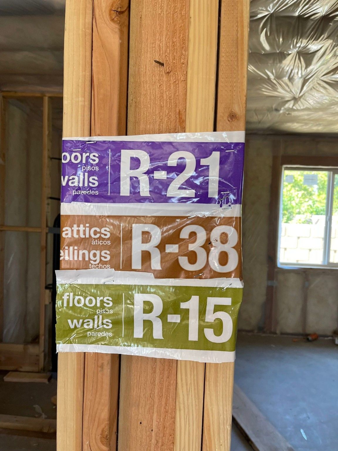 Insulation labels attached to a wood stud on a construction site