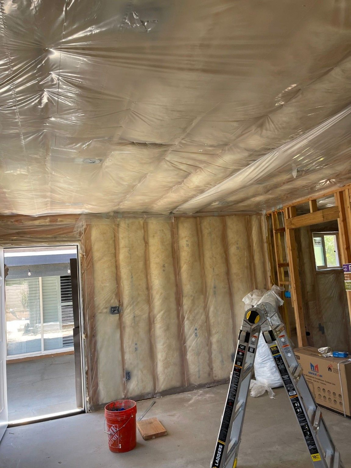 Room under construction with insulation at the walls and ceiling
