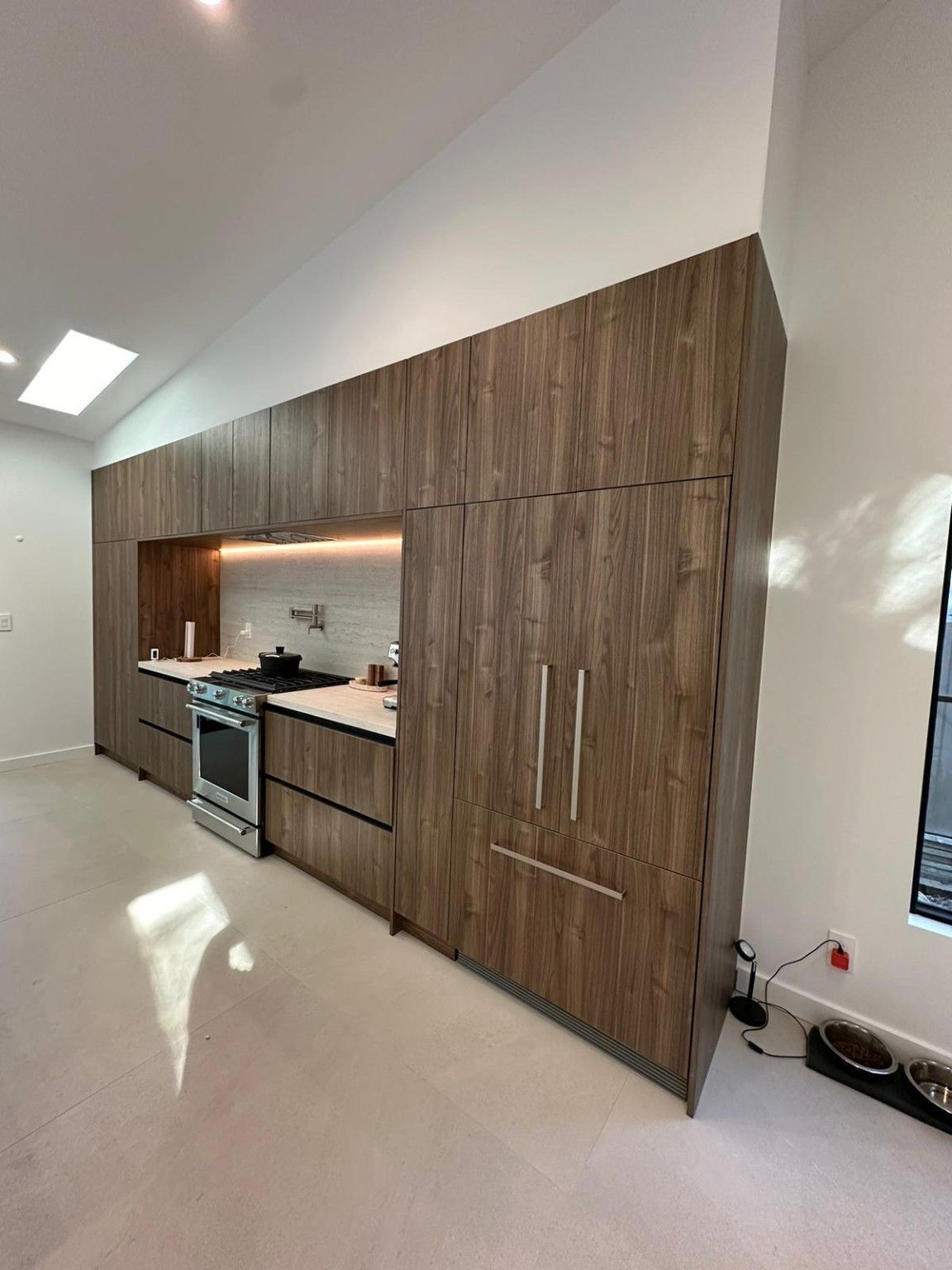Tall wood kitchen cabinetry with an inset counter and backsplash