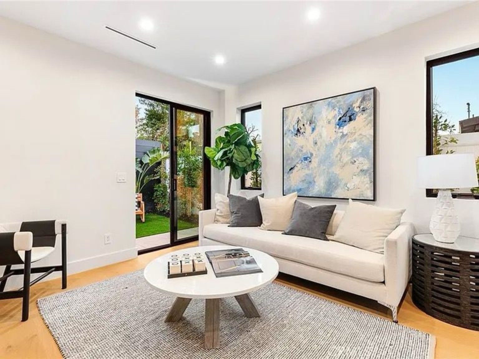 Living room with glass doors connecting the interior to an outdoor seating area