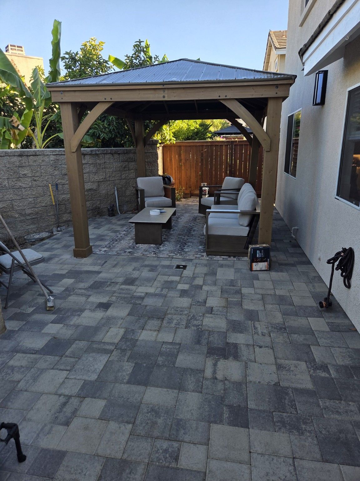 Paver patio with a gazebo and outdoor seating